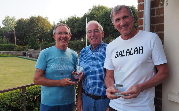 Brian Hearne presents trophy to mens doubles champions Richard Davies and Hardijs Madzulis